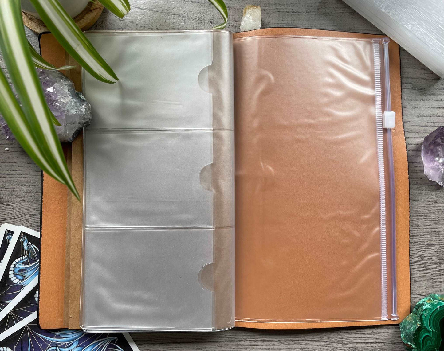 Pictured is a faux leather refillable notebook with a crystal. Faux Leather Divination Circle Refillable Notebook (Black) zipper pocket