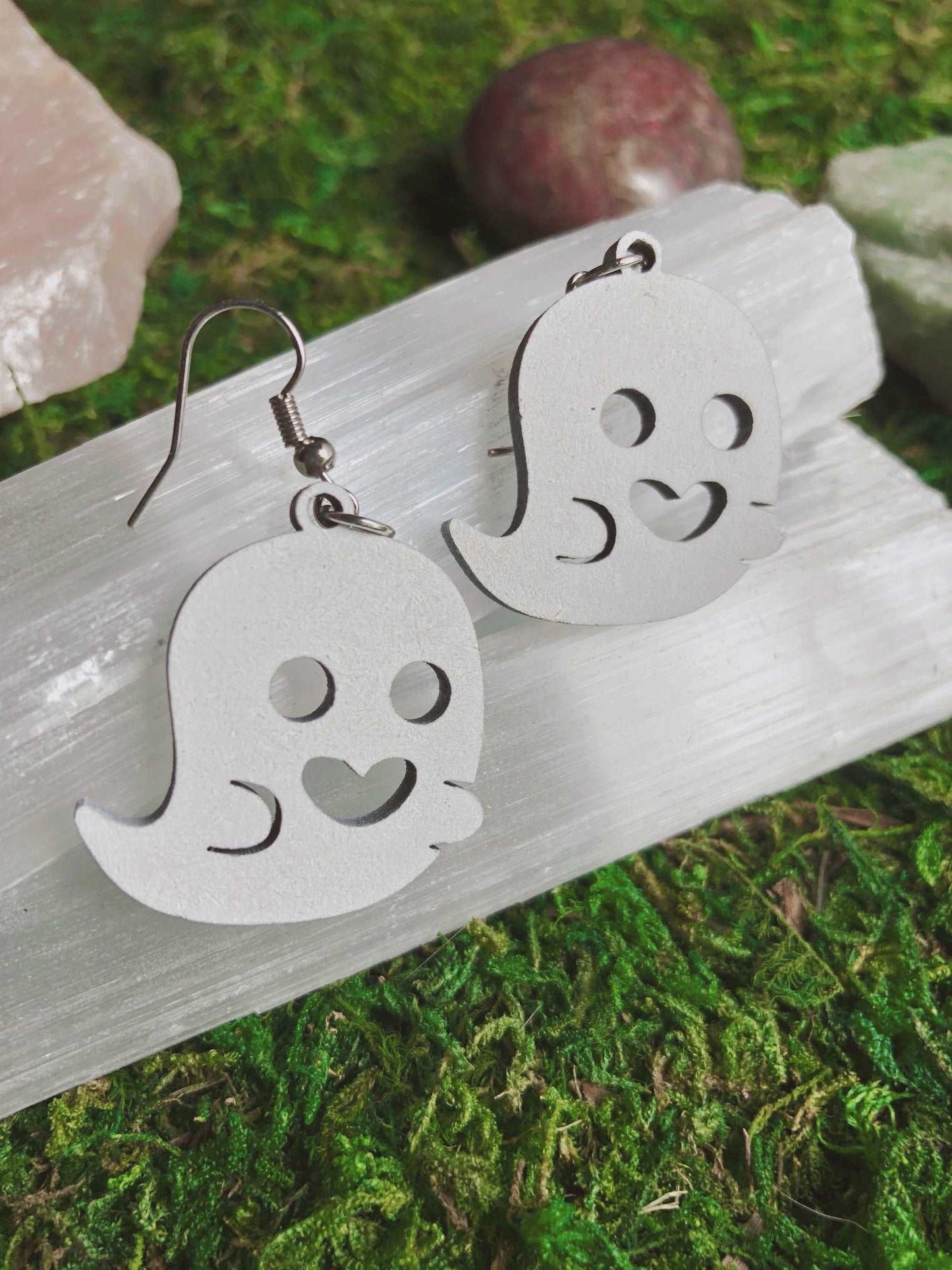 Pictured is a pair of earrings featuring a cute white ghost. They are made of wood. Cute Ghost Earrings
