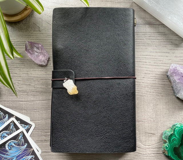 Pictured is a faux leather refillable notebook with a crystal. Faux Leather Spiritual Symbols Refillable Notebook (Black) back