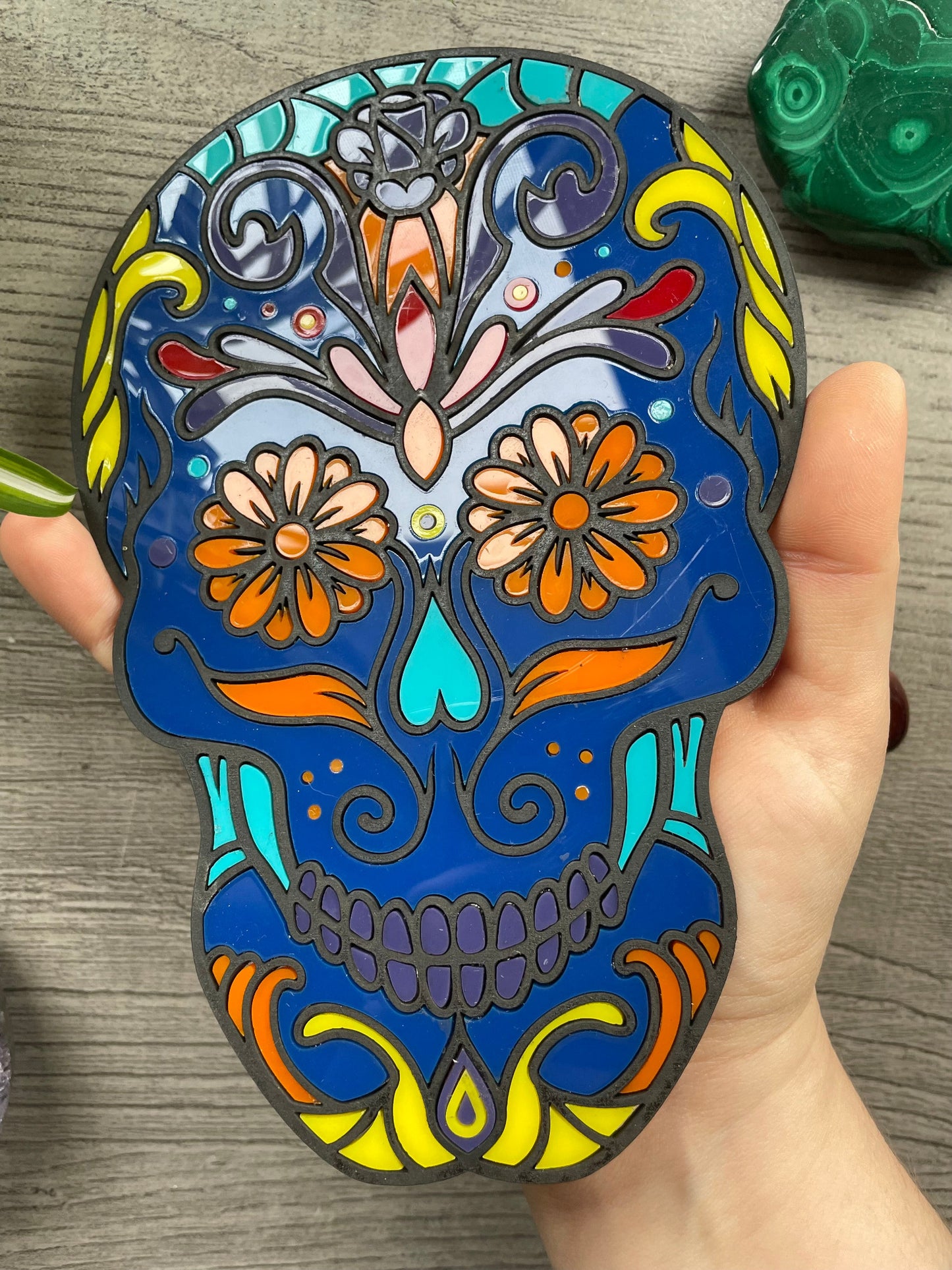 Pictured is a faux stained glass sugar skull made out of wood and acrylic. Sugar Skull Wall Art (Blue) close up