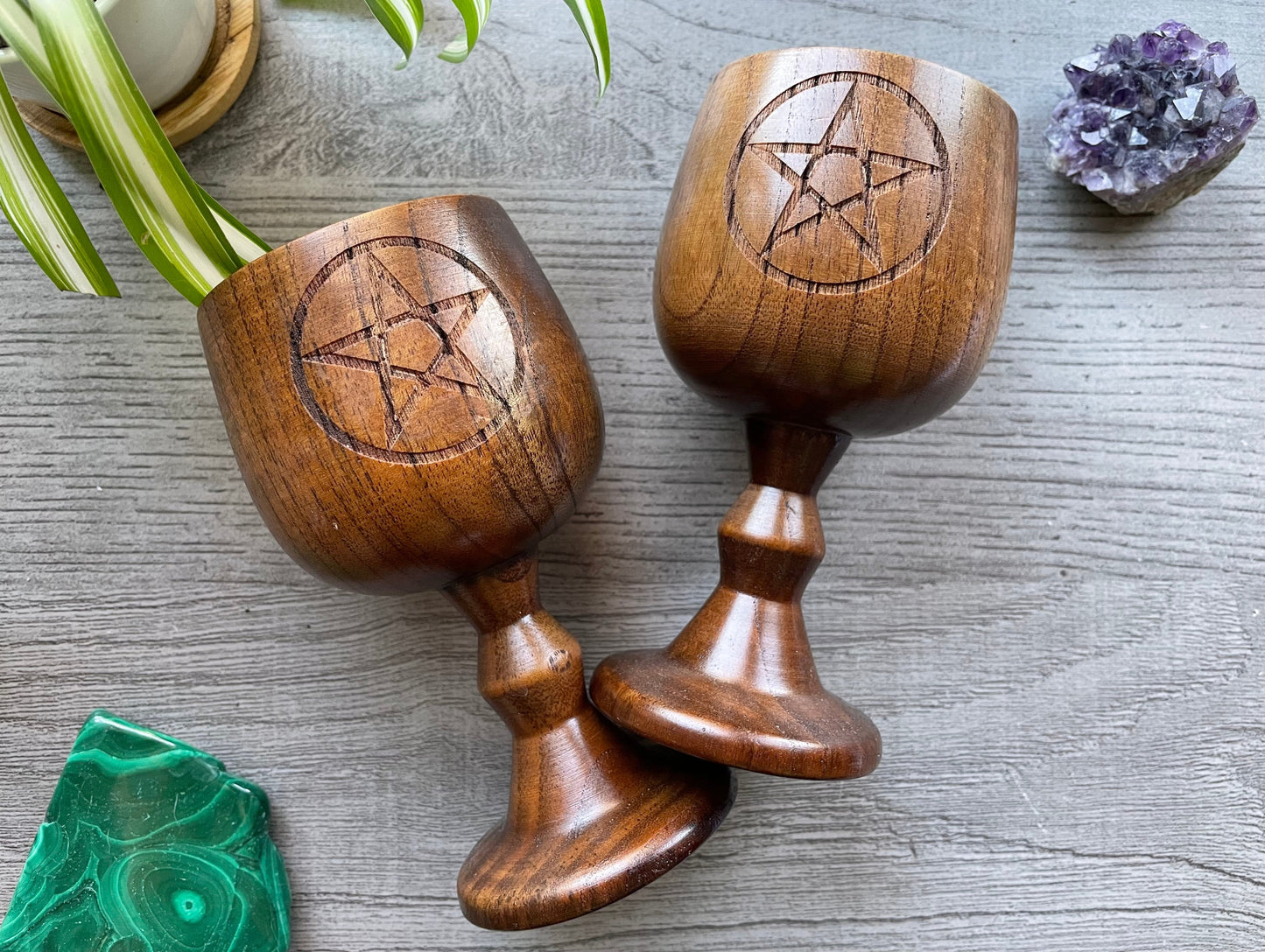 Pictured are various wood goblets with pentagrams on them.