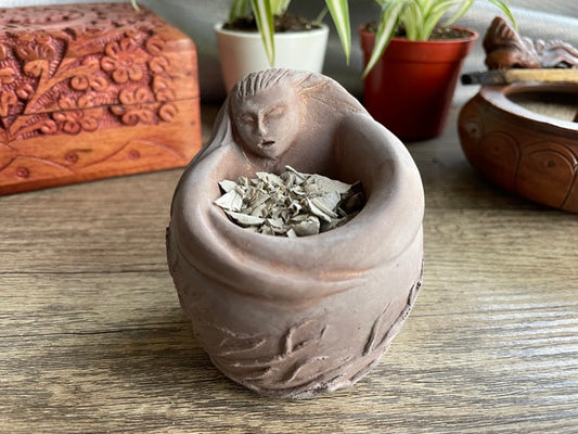 Pictured is an incense bowl or offering bowl carved out of gypsum in the shape of a goddess. Mother Spirit/Goddess Offering Bowl & Incense Holder front