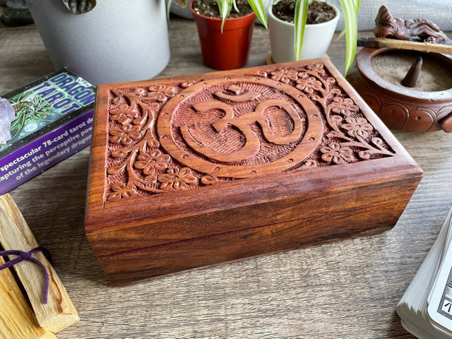 Pictured is hand-carved wood box with the "OM" symbol in the middle. OM Symbol Carved Wooden Box front