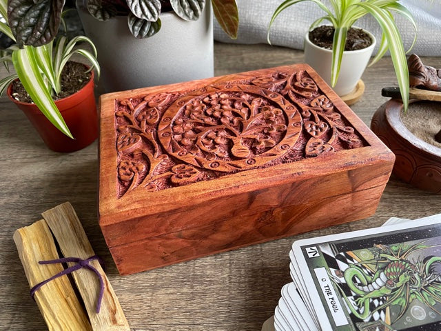 Pictured is hand-carved wood box with a tree of life in the middle. Tree of Life Carved Wooden Box front