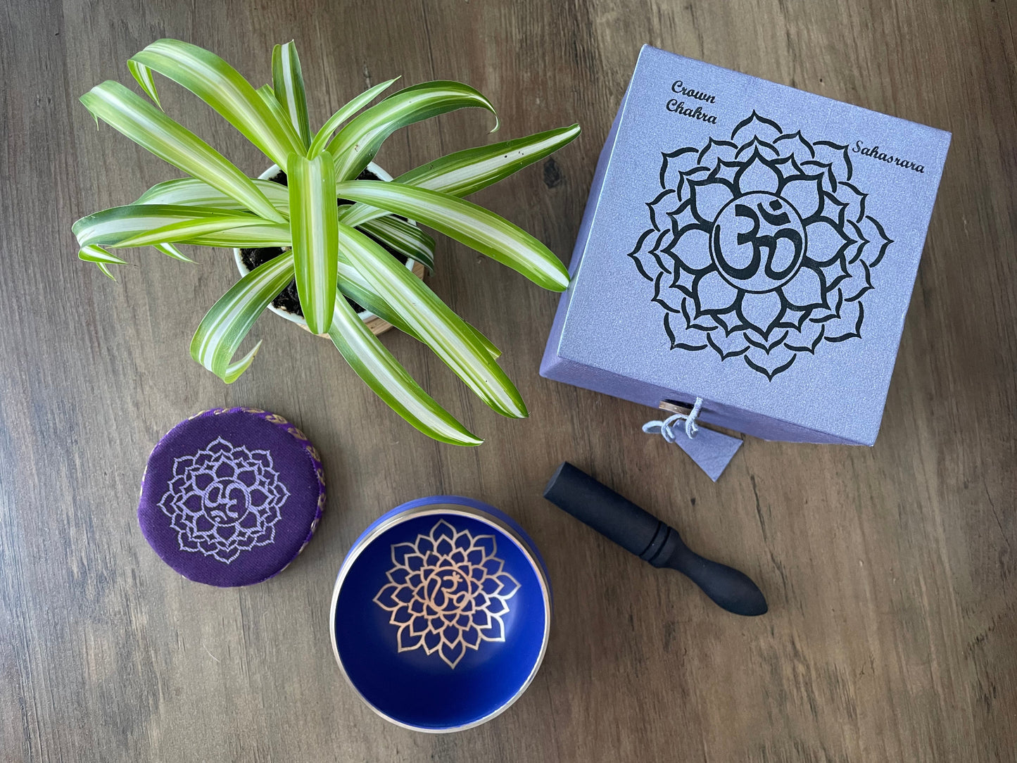 Pictured is a small metal singing bowl with a pillow and a wood gong mallet. Purple Singing Bowl (Crown Chakra) 8cm top