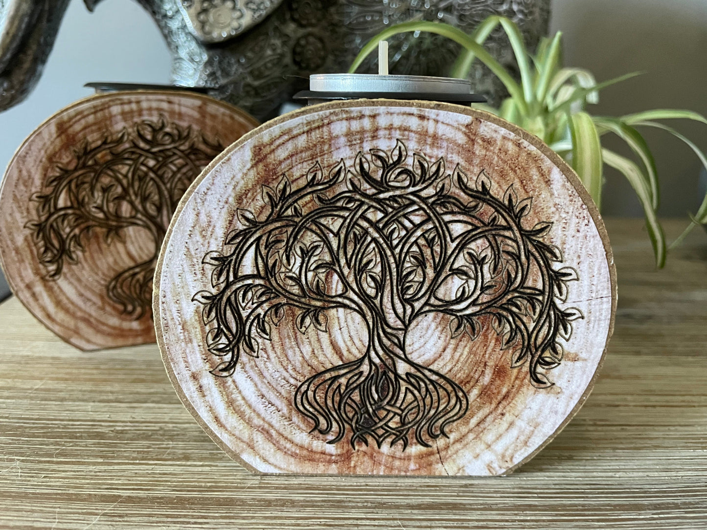 Pictured is a wood tree slice candle holder with a tree of life envraged on it. Tree of Life Engraved Wooden Candle Holder close up
