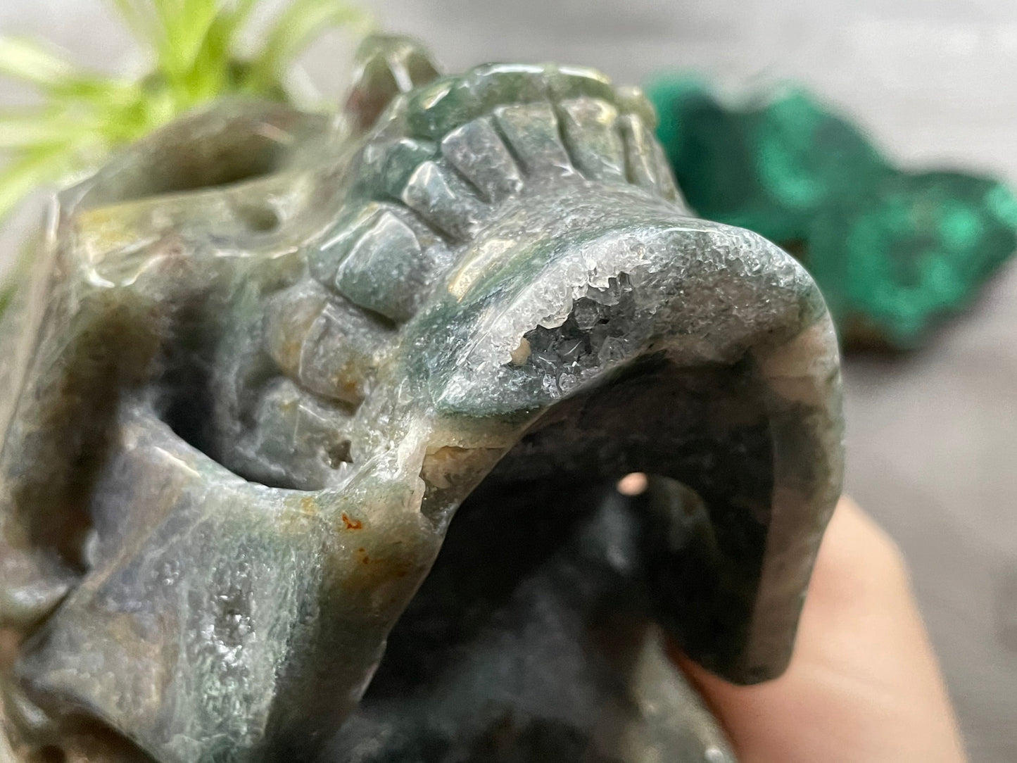 Pictured is a large skull Moss Agate Crystal Skull (1.15kg) - The Wandering Fox Emporium, Your Metaphysical Store close up 2out of moss agate.