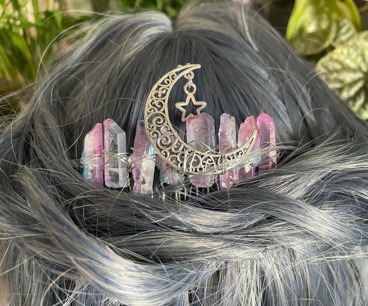 Pictured are various aura quartz hair combs with silver crescent moons on them. Pink & Blue Quartz Aura Crystal Comb - The Wandering Fox Emporium, Your Metaphysical Store close up