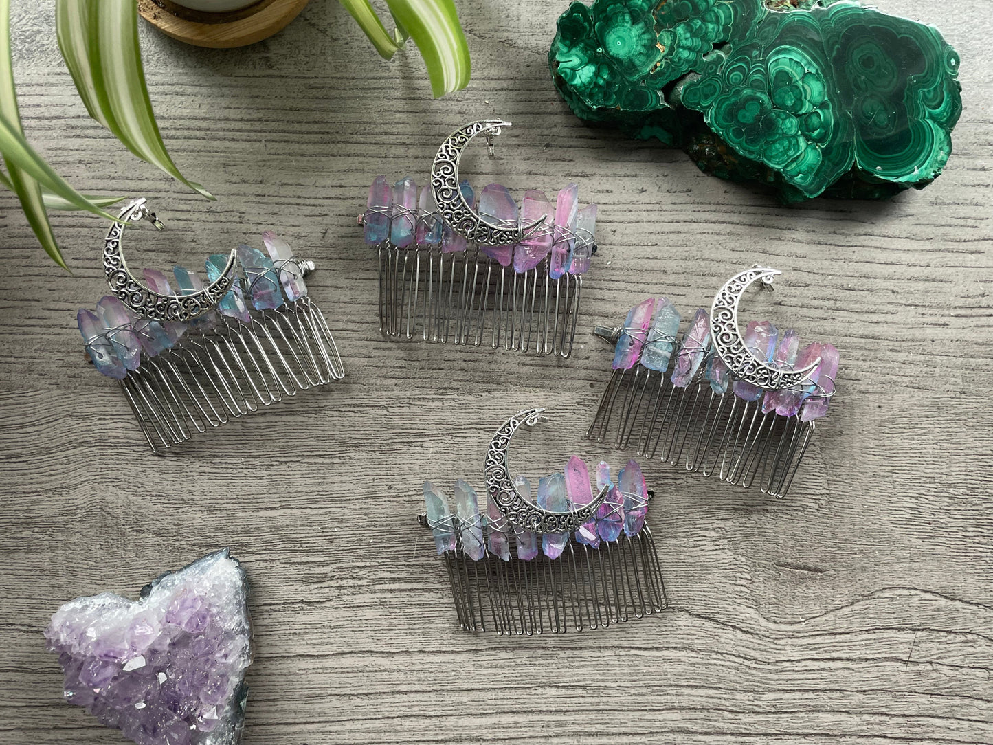 Pictured are various aura quartz hair combs with silver crescent moons on them. Pink & Blue Quartz Aura Crystal Comb - The Wandering Fox Emporium, Your Metaphysical Store selection