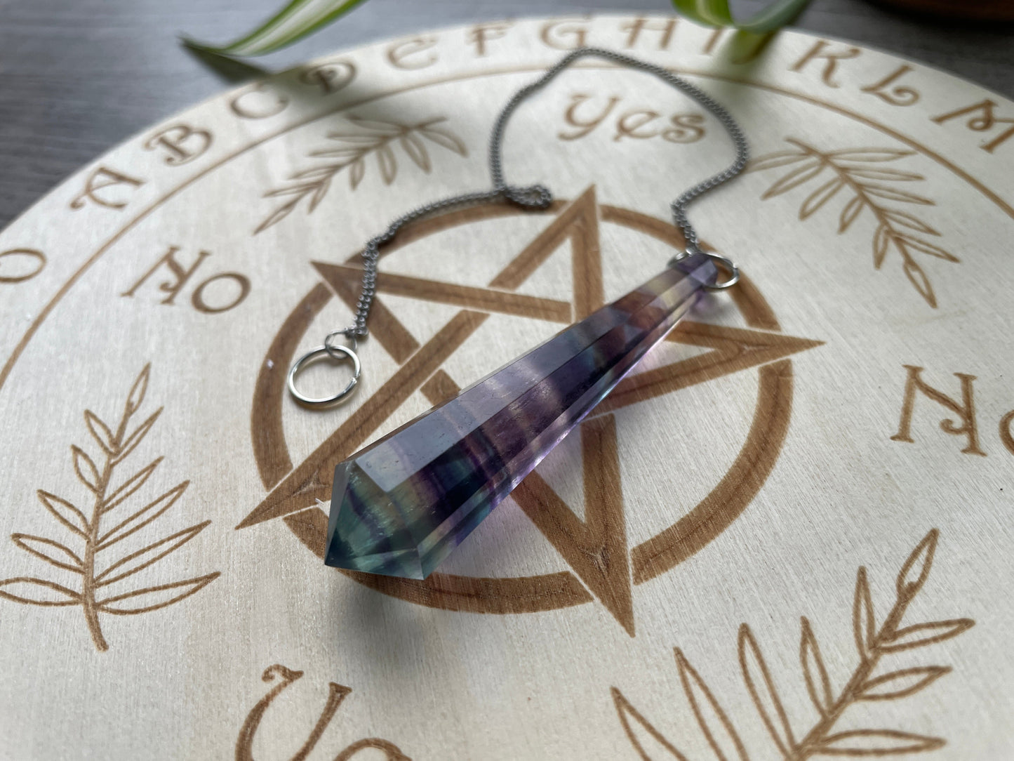 Rainbow Fluorite 8-Sided Crystal Pendulum (B) on board