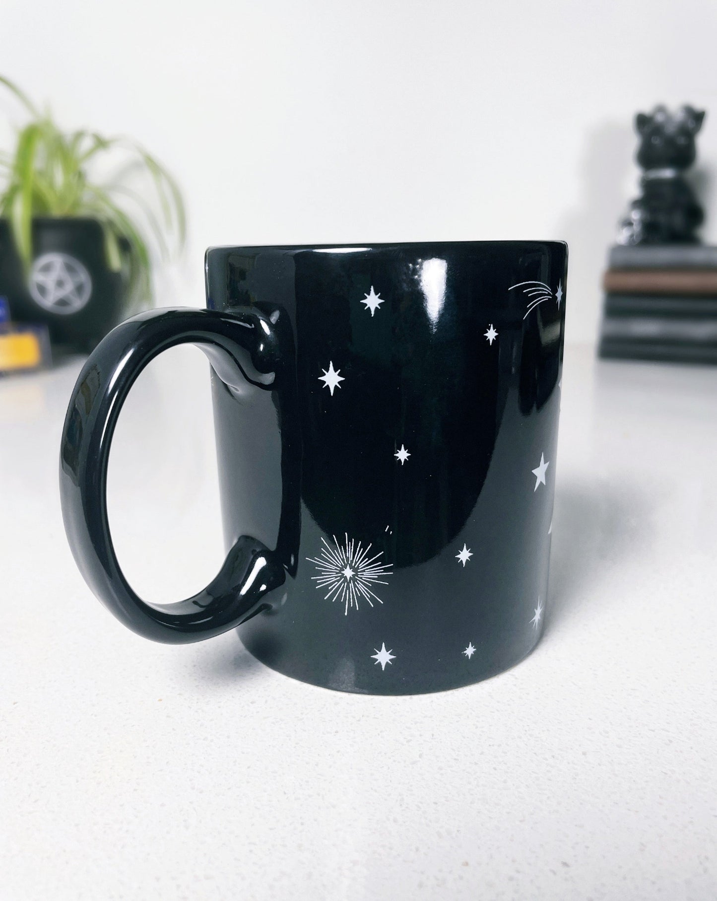 Pictured is a black ceramic mug with a triple moon on it. Triple Moon Ceramic Mug handle