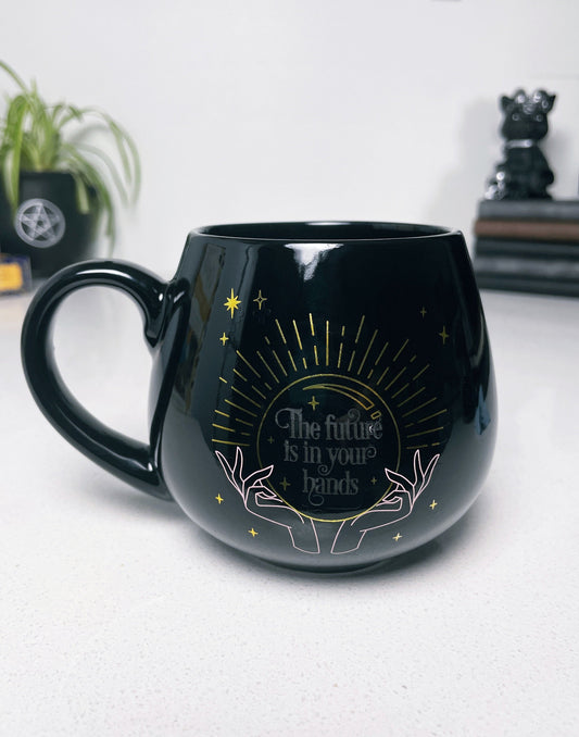 Pictured is a black ceramic mug with colour-changing words that say "The future is in your hands". Colour-changing Fortune Ceramic Mug close up