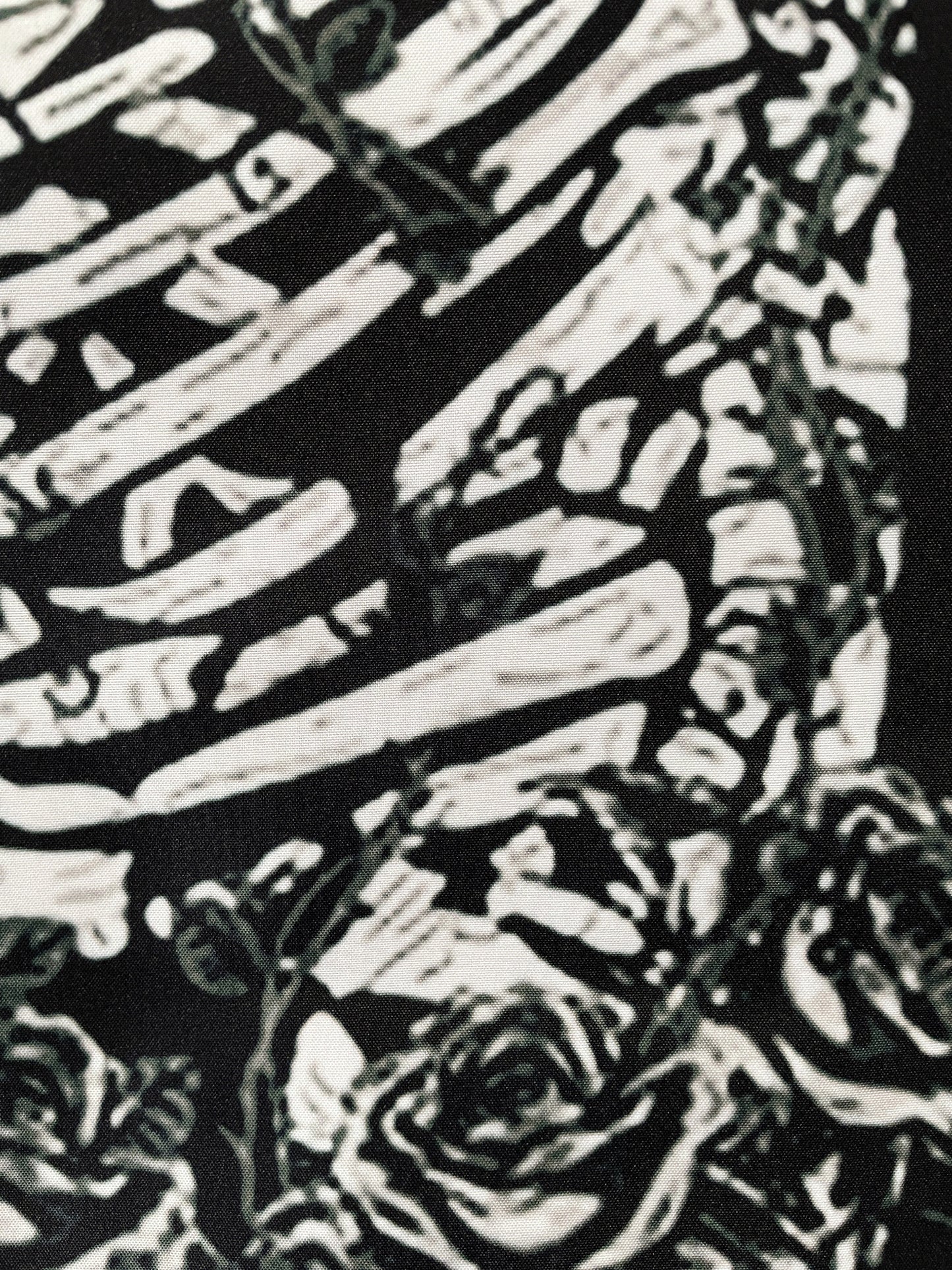 Pictured is a large wall tapestry with a black background and two skeletons kissing on a tarot card "the lovers" printed in white on it. The Lovers Wall Tapestry example