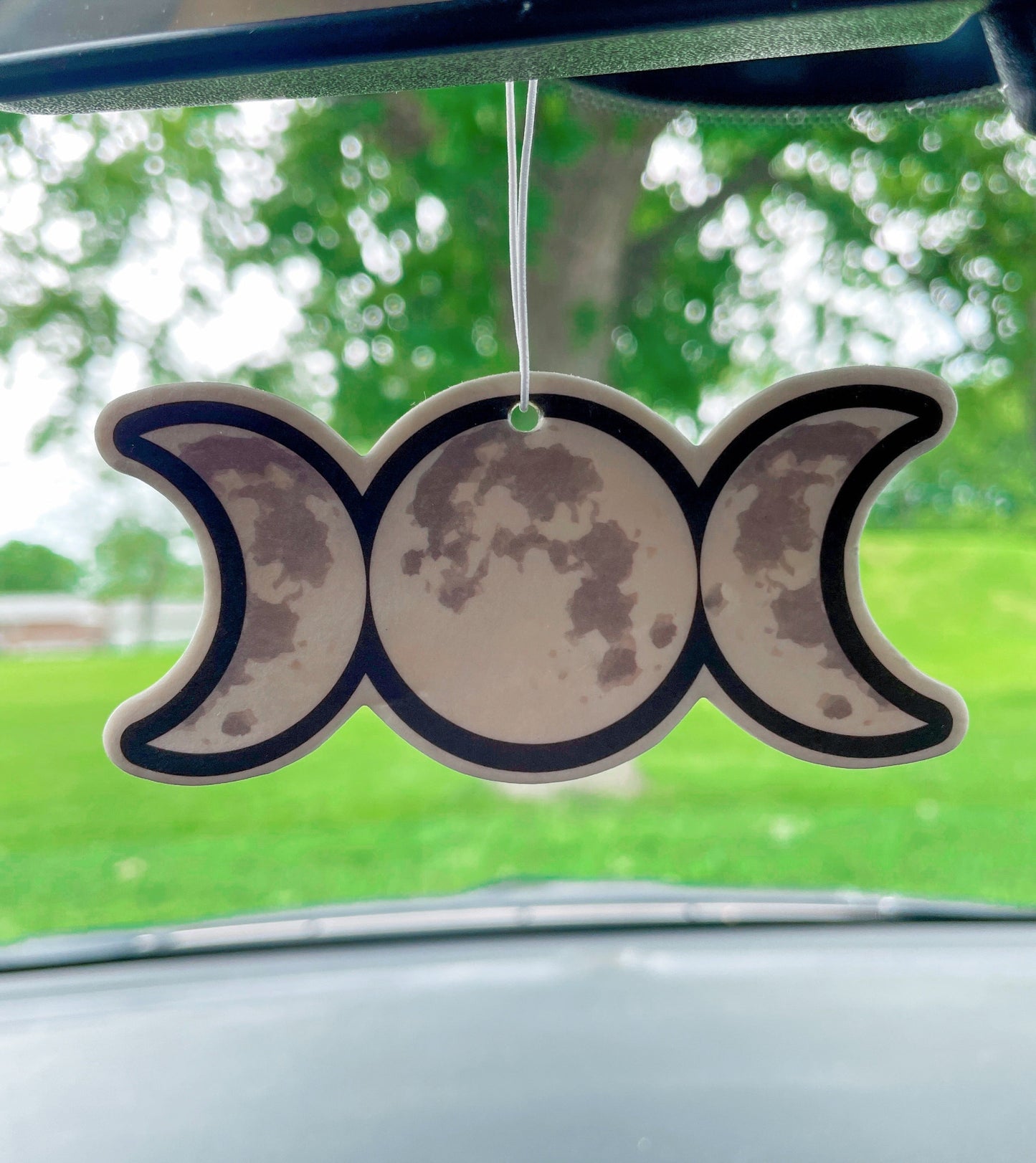 Pictured is an air freshener in the shape of a triple moon symbol Triple Moon Air Freshener (Vanilla Scent)