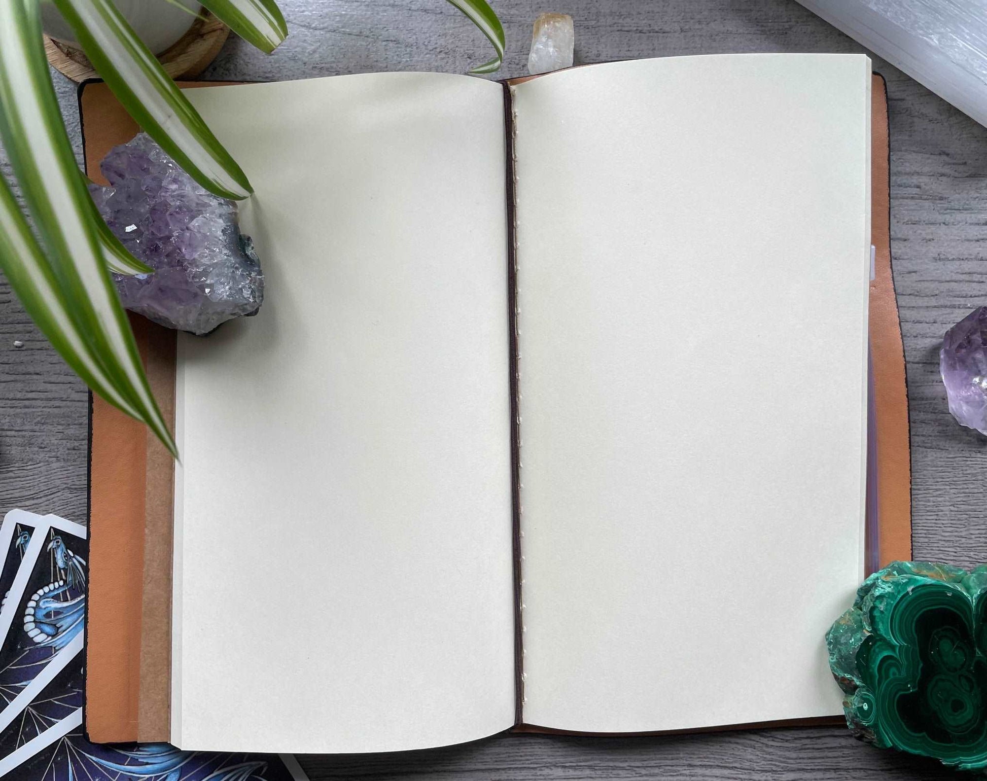 Pictured is a faux leather refillable notebook with a crystal. Faux Leather Spiritual Symbols Refillable Notebook (Black) blank