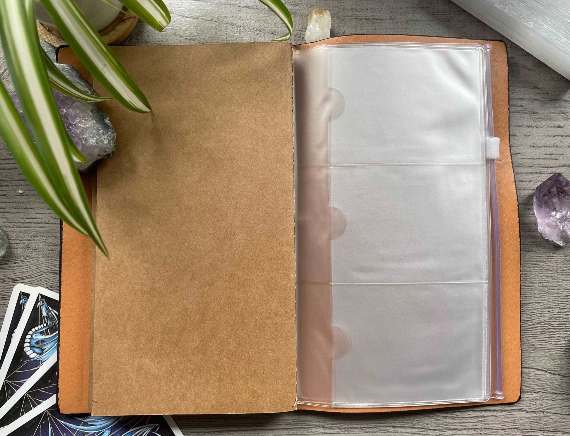 Pictured is a faux leather refillable notebook with a crystal. Faux Leather Spiritual Symbols Refillable Notebook (Black) card holder