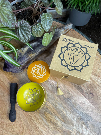 Pictured is a small metal singing bowl with a pillow and a wood gong mallet. Yellow Singing Bowl (Solar Plexus Chakra) 8cm