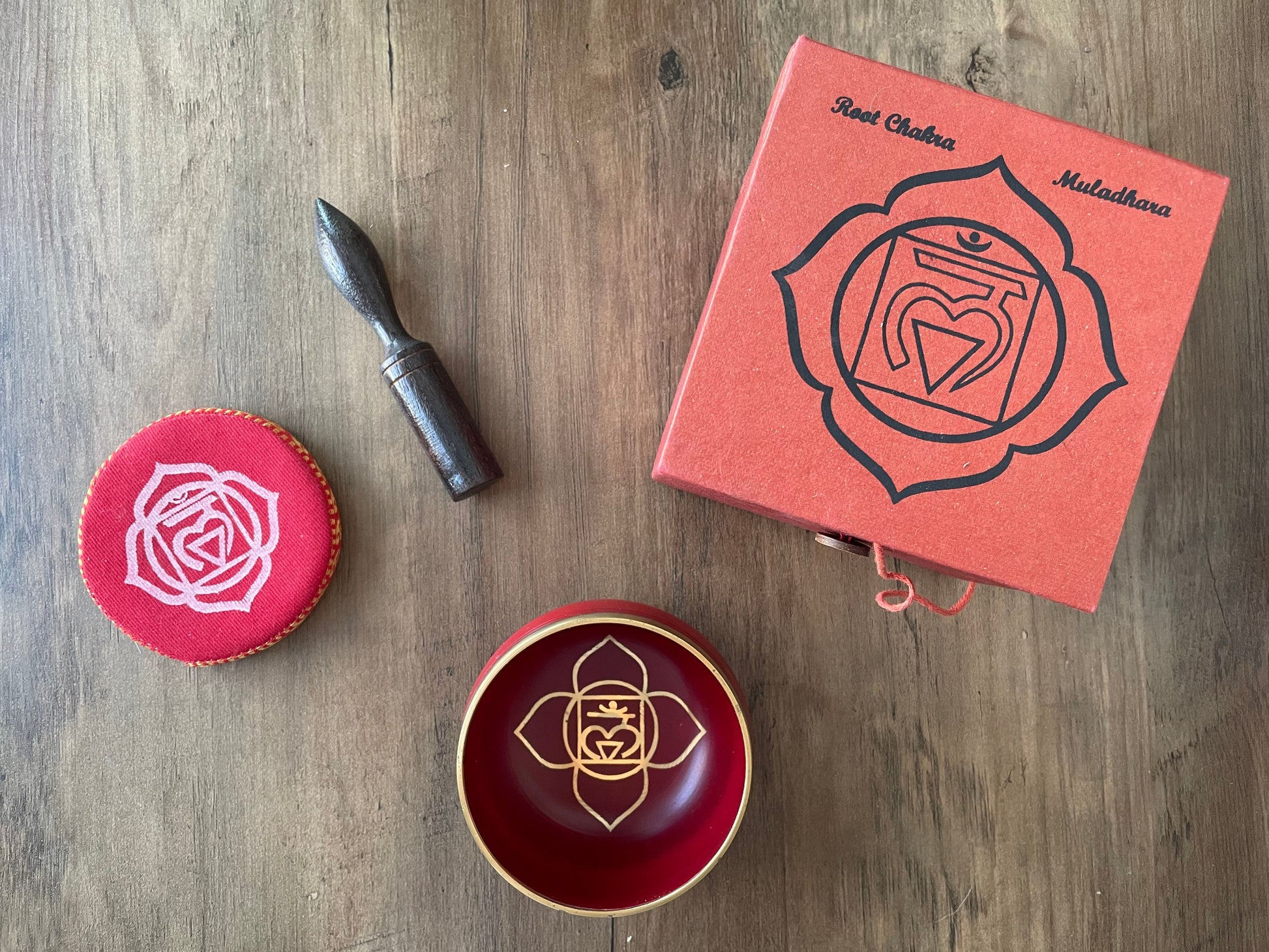 Pictured is a small metal singing bowl with a pillow and a wood gong mallet. Red Singing Bowl (Root Chakra) 8cm top