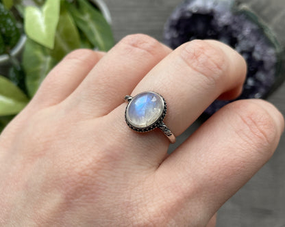 Pictured is a white moonstone gemstone set in an S925 sterling silver ring. White Moonstone S925 Sterling Silver Ring (J) - The Wandering Fox Emporium, Your Crystal Store side