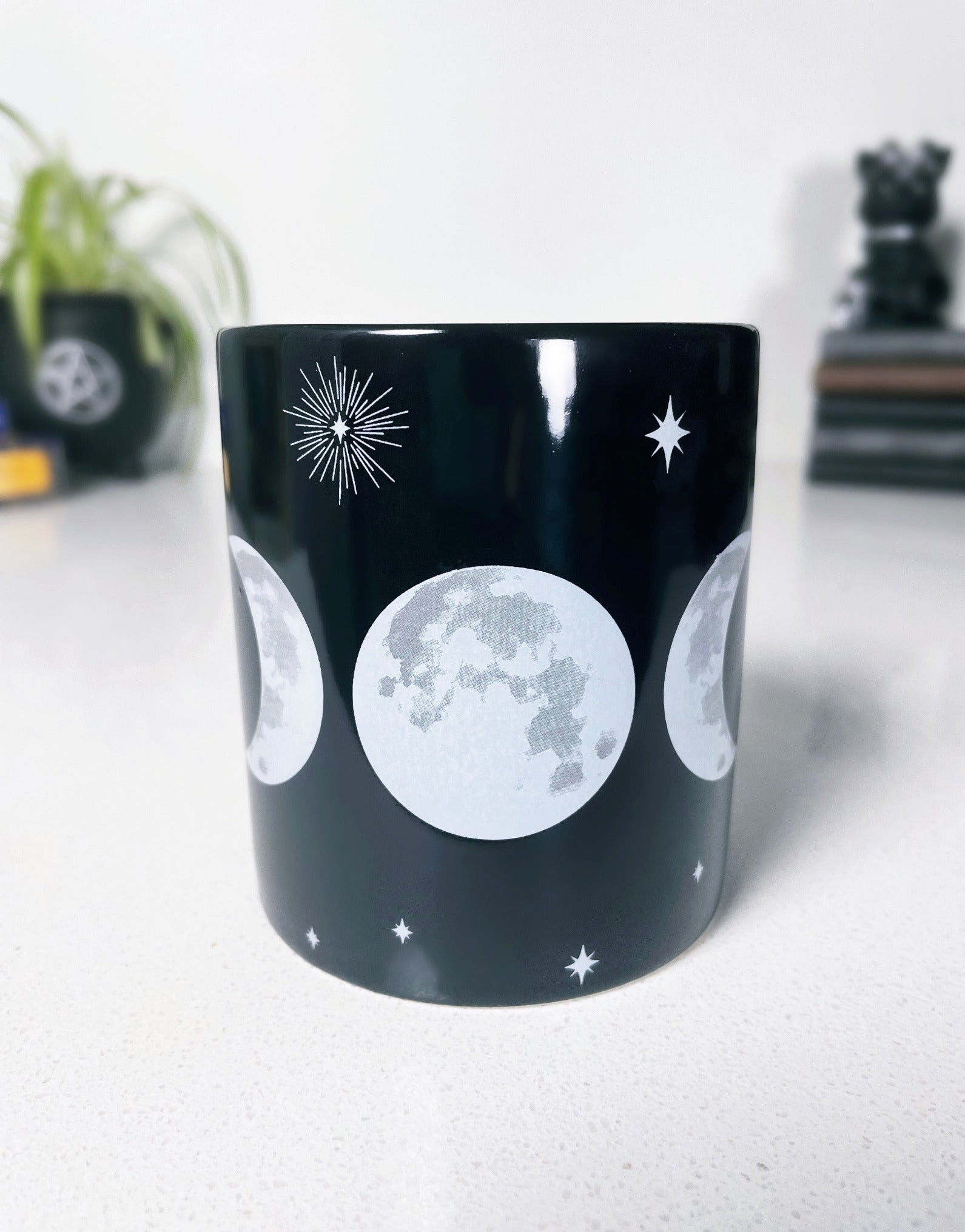 Pictured is a black ceramic mug with a triple moon on it. Triple Moon Ceramic Mug front